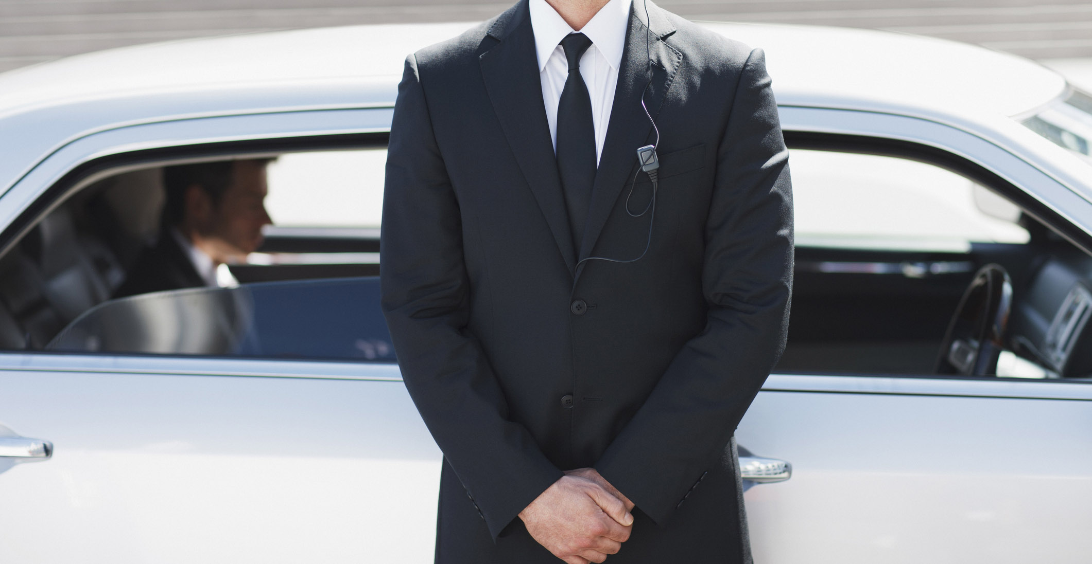 Security guard standing by car